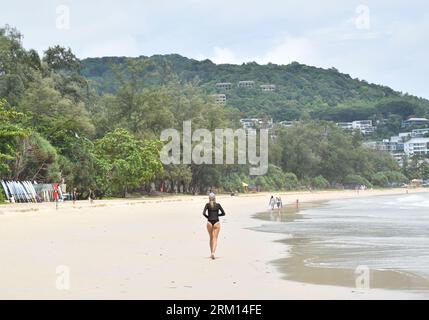 Lady Walking sulla spiaggia sabbiosa di Phuket in Thailandia. Foto Stock