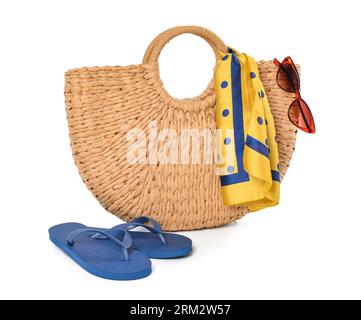 Wicker beach bag, sunglasses and flip-flops on white background Stock Photo