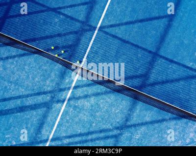 immagine aerea zenitale di cinque palle su un campo da tennis in erba artificiale blu Foto Stock