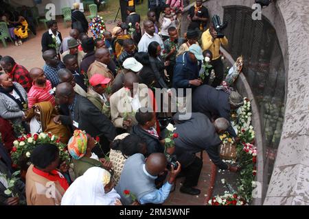 (130807) -- NAIROBI, Aug. 7, 2013 (Xinhua) -- Survivors of the 1998 bomb blast present flowers to the victims during the 15th annual commemoration at the August 7th Memorial Park in Nairobi, capital of Kenya, Aug. 7, 2013. Survivors congregated here on Wednesday to commemorate the victims of the 1998 bomb when the American Embassy building in Nairobi of Kenya and Dar-es-Salaam of Tanzania were bombed by terrorists on August 7th, 1998, killing 224 and injuring over 4,500. (Xinhua/Ali Alale)(cxy) KENYA-NAIROBI-1998 BOMB BLAST-COMMEMORATION PUBLICATIONxNOTxINxCHN Stock Photo