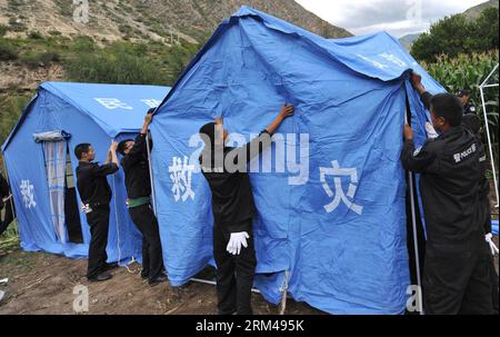 Bildnummer: 60404502  Datum: 28.08.2013  Copyright: imago/Xinhua SHANGRI-LA, Aug. 28, 2013 - Police set up tents for displaced villagers in the quake-hit Shangqiaotou Village in the Tibetan Autonomous Prefecture of Deqen, southwest China s Yunnan Province, Aug. 28, 2013. An earthquake measuring 5.1 on the Richter scale jolted the junction area of southwest China s Yunnan and Sichuan provinces on Wednesday. No casualties have been reported, although the quake has destroyed dozens of houses and cut off road traffic and telecommunications. (Xinhua/Lin Yuguang) (hdt) CHINA-YUNNAN-QUAKE (CN) PUBLIC Stock Photo