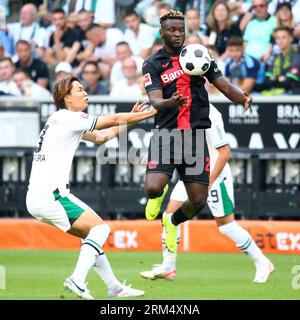 Moenchengladbach, Germania. 26 agosto 2023. Itakura Ko (L) del Borussia Moenchengladbach vies con Victor Okoh Boniface del Bayer 04 Leverkusen durante la loro partita di secondo turno in Bundesliga a Moenchengladbach, Germania, 26 agosto 2023. Crediti: Ulrich Hufnagel/Xinhua/Alamy Live News Foto Stock