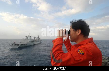 (140318) -- A BORDO della NANHAIJIU 101, 18 marzo 2014 (Xinhua) -- vice comandante della nave di salvataggio cinese Nanhaijiu 101 Zhang Jianxin osserva come la nave si avvicina alla nave di rifornimento completa Qiandaohu, mentre entrambe si dirigono verso Singapore per unirsi alla ricerca del volo MH370 della Malaysia Airlines mancante, 18 marzo 2014. Alle 8:00 di martedì, il Ministero dei trasporti cinese ha ordinato a tutte le navi cinesi nel Golfo della Thailandia di partire per le ricerche nelle acque a sud-est della Baia del Bengala e vicino allo stretto della Sunda. (Xinhua/Zhao Yingquan) NANHAIJIU 101-CINA-NAVI DI SALVATAGGIO PUBLICATIONxNOTx Foto Stock