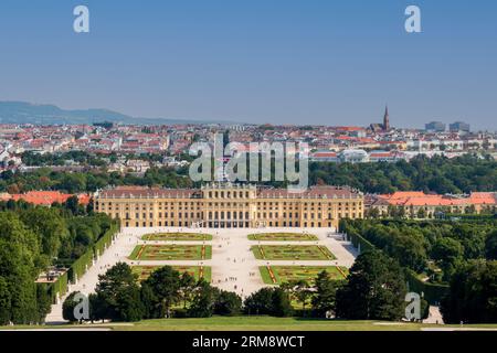 Ammira i meravigliosi giardini e il palazzo del Parco del Palazzo Schönbrunn verso le case e gli edifici del centro di Vienna in una giornata calda Foto Stock