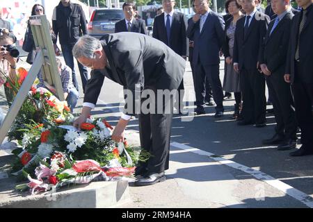 (140507) -- BELGRADO, 7 maggio 2014 (Xinhua) -- l'ambasciatore cinese in Serbia Zhang Wanxue (fronte) mostra rispetto per tre giornalisti cinesi uccisi nel bombardamento NATO guidato dagli Stati Uniti dell'ambasciata cinese a Belgrado, di fronte a un monumento a Belgrado, capitale della Serbia, il 7 maggio 2014. Shao Yunhuan della Xinhua News Agency insieme a Xu Xinghu e sua moglie Zhu Ying del quotidiano Guangming Daily di Pechino sono stati uccisi nell'attacco missilistico che ha inflitto gravi danni agli edifici dell'ambasciata la sera del 7 maggio 1999. (Xinhua/Wang Hui) SERBIA-BELGRADO-CINA-GIORNALISTI-COMMEMORAZIONE PUB Foto Stock