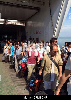 (140520) -- HAIKOU, 20 maggio 2014 (Xinhua) -- cittadini cinesi sbarcano dalla nave passeggeri Wuzhishan dopo che la nave è arrivata al porto Xiuying di Haikou, capitale della provincia di Hainan della Cina meridionale, il 20 maggio 2014. Il primo gruppo di lavoratori cinesi colpiti dalla violenza in Vietnam è arrivato al porto di Haikou martedì mattina. Domenica il governo cinese ha inviato quattro navi per evacuare i lavoratori cinesi colpiti dalla sommossa in Vietnam, dove dal 13 maggio le violenze violente contro le aziende straniere hanno causato la morte di due cittadini cinesi e oltre 100 feriti. (Xinhua/Xia Yifang) (lfj) CHIN Foto Stock