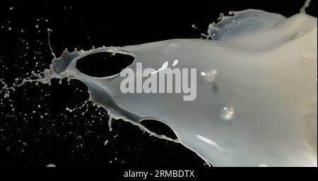 Esplosione del latte su sfondo nero Foto Stock