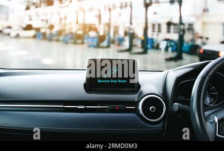 Avviso di manutenzione visualizzato sullo schermo, simbolo di intervento di manutenzione a breve sul cruscotto dello schermo dell'auto, manutenzione dell'auto presso il centro di riparazione auto Foto Stock