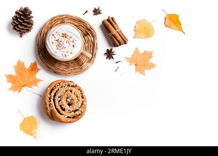 Sfondo autunnale con caffè e panino alla cannella per colazione o per una pausa isolata su uno spazio bianco, copia. Tazza di caffè cappuccino con l autunnale di stagione Foto Stock