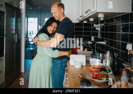 Amare giovane costeggiata in cucina Foto Stock
