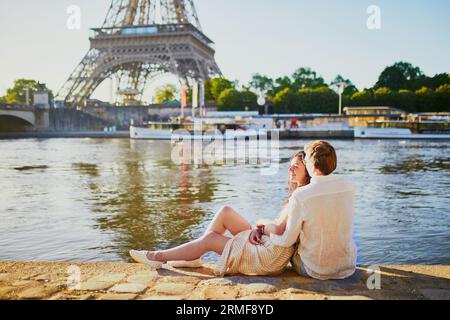 Felice coppia romantica a Parigi, vicino alla Torre Eiffel. Turisti che trascorrono le loro vacanze in Francia Foto Stock