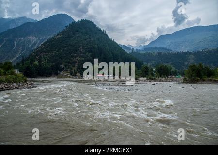 Keran Kupwara, India. 25 agosto 2023. Visione generale del fiume Neelam o Kishan Ganga che ha diviso il Kashmir in due parti controllate dai rivali nucleari India e Pakistan. Il fiume funge da linea di controllo contesa e scorre attraverso un villaggio chiamato Keran da entrambi i lati che si trova sul lato settentrionale del distretto di confine del Kashmir indiano Kupwara a circa 150 km da Srinagar e 93 km da Muzaffarabad, nel lato pakistano del Kashmir. Credito: SOPA Images Limited/Alamy Live News Foto Stock