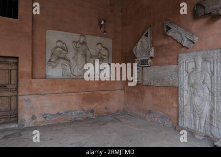 MARMI E SCULTURE DI EPOCA ROMANA SULLE PARETI DEL PORTICO DELLA BASILICA DI SAN LORENZO IN LUCINA Foto Stock