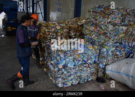 29 agosto 2023, città di Malang, Giava Orientale, Indonesia: il 29 agosto 2023 due lavoratori controllano i fasci separati di plastica e carta nell'area delle macchine di smistamento presso la discarica di rifiuti Supiturang a Malang, Giava Orientale, Indonesia. questa città utilizza già un sistema sanitario di discarica, che in precedenza utilizzava un sistema di scarico aperto nelle discariche di rifiuti (immagine di credito: © Aman Rochman/ZUMA Press Wire) SOLO USO EDITORIALE! Non per USO commerciale! Foto Stock