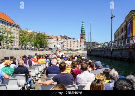 Copenaghen, Danimarca - 30 maggio 2023: Crociera turistica in barca con vista sul canale per gli edifici storici della città e l'argine Foto Stock