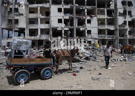 (140804) -- STRISCIA DI GAZA, 4 agosto 2014 -- i palestinesi raccolgono beni dalla loro casa distrutta nella città settentrionale di Beit Lahiya, nella Striscia di Gaza, il 4 agosto 2014. Dall'inizio dell'offensiva israeliana sulla Striscia di Gaza, 1.868 palestinesi sono stati uccisi e più di 9470 feriti, ha detto Ashraf al-Qedra, portavoce del ministero della salute a Gaza. ) MIDEAST-GAZA-ISRAELE-ATTACCO AEREO WissamxNassar PUBLICATIONxNOTxINxCHN Striscia di Gaza 4 agosto 2014 PALESTINESI raccolgono l'appartenenza dalla loro Casa distrutta nella città di Beit Lahiya nella Striscia di Gaza settentrionale IL 4 agosto 2014 dall'INIZIO degli israeliani Foto Stock