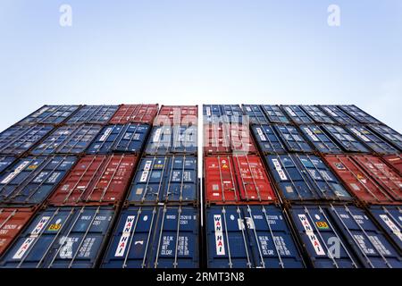 Bangkok, Thailand - July 9, 2023 : Low angle view of stack of container in logistic port harbour waiting to moving to international cargo ship. Stock Photo