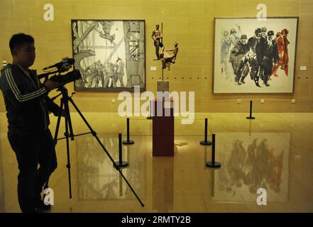 (140923) -- PECHINO, 23 settembre 2014 -- Un cameraman opere alla mostra nel National Art Museum of China (NAMOC) a Pechino, capitale della Cina, 23 settembre 2014. Sponsorizzata dal Ministero della Cultura della Cina, al NAMOC di Pechino si apre la mostra Chinese Dream - Art Exhibition on Celebration of the 65th Anniversary of the Founding of the People's Republic of China. (Wyl) CHINA-BEIJING-ART EXHIBITION-65TH ANNIVERSARY (CN) LuxPeng PUBLICATIONxNOTxINxCHN Pechino 23 settembre 2014 un cameraman lavora alla Exhibition nel National Art Museum of China NAMOC di Pechino capitale della Cina 23 settembre 201 Foto Stock