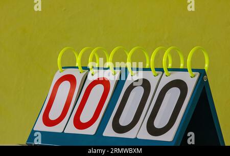 a picture of a badminton scoreboard. on a yellow background. Stock Photo