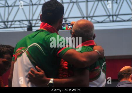 Il capitano Mashrafe Bin Mortaza e il capo allenatore Chandika Hathrusingha scattano dei selfie durante i giocatori di cricket nazionali del Bangladesh che ricevono un caloroso benvenuto da parte del Foto Stock