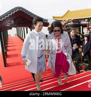 POLITIK Firstladys am Rande des APEC Gipfels a Pechino (141111) -- PECHINO, 11 novembre 2014 -- Peng Liyuan (L), moglie del presidente cinese Xi Jinping, offre una mano a Rosmah Mansor, moglie del primo ministro malese Najib Razak, mentre lasciano un molo sul lago Kunming nel Palazzo estivo di Pechino, in Cina, 11 novembre 2014. Peng ha invitato le mogli di alcuni leader e rappresentanti delle economie membri della cooperazione economica Asia-Pacifico (APEC) a visitare il Palazzo d'Estate martedì. )(LMM) (APEC 2014) CHINA-BEIJING-PENG LIYUAN-APEC-SPOSES-SUMMER PALACE (CN) HUANGXJINGWEN PUBLICATIONXNOTXINXCH Foto Stock