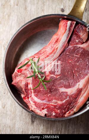 Raw T-bone Steak In A Copper Pan Stock Photo