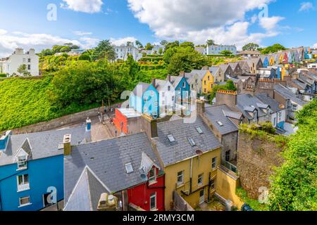 Il pittoresco e colorato Deck of Cards, una fila di case cittadine dipinte con colori vivaci, viste dal parco Garden of Reflection di Cobh, Irlanda. Foto Stock