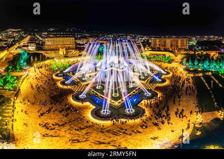 Aerial view to largest light and music fountain in Russia. 2214 colours jets burst into sky with musical accompaniment. Night show fire on the water i Stock Photo