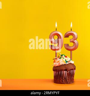 Candle with flame number 93 - Birthday card on yellow background Stock Photo