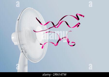 Ventilatore elettrico portatile con nastri fluttuanti su sfondo blu. Foto Stock