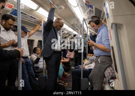 A busy carriage of commuters on the London Underground returning to work after the summer break, central London, England, United Kingdom Stock Photo