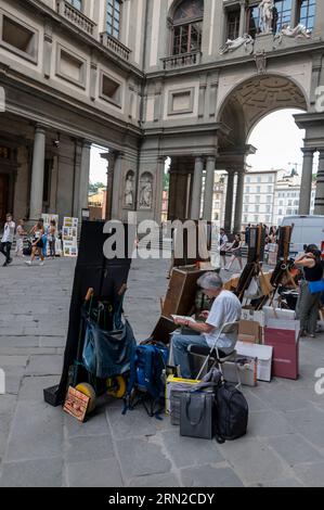 Una linea di artisti che dipingono e vendono le loro opere ai turisti in visita all'interno del Loggiato, un cortile semi-chiuso che fa parte della Galleria de Foto Stock