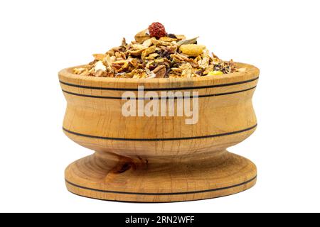 Dried winter tea. Sun-dried winter tea in wood bowl isolated on white background. herbal medicine Stock Photo