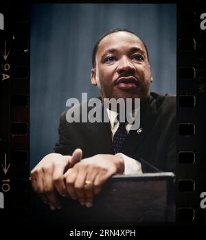 Martin Luther King press conference 1964 Mar. 26. Photograph shows head-and-shoulders portrait of King leaning on a lectern. Stock Photo