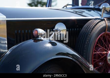 Waltershausen, Germany - June 10, 2023: A vintage Rolls Royce Phantom. View of the turning lamp and rear-view mirror. Stock Photo