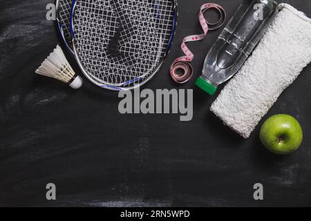 Composizione con bottiglia d'acqua di badminton mela Foto Stock