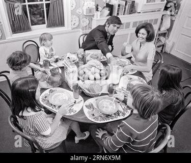 1970s LARGE FAMILY SEATED AROUND BREAKFAST TABLE - d6099 HAR001 HARS DAD INDOOR MEAL BREAKFAST LARGE MOM INDOORS BREAD NOSTALGIC GETTING MOTHERS OLD TIME BUSY FUTURE NOSTALGIA BROTHER OLD FASHION SISTER JUVENILE SECURITY CIRCLE SAFETY CEREAL SONS JOY LIFESTYLE SATISFACTION STARTING FEMALES READY BROTHERS HUSBANDS HEALTHINESS HOME LIFE SEATED FULL-LENGTH HALF-LENGTH LADIES DAUGHTERS PERSONS INSPIRATION MALES SERENITY SIBLINGS CONFIDENCE SISTERS FATHERS HUSBAND AND WIFE B&W MORNING HUSBANDS AND WIVES GOALS HOMEMAKER FATHERHOOD HAPPINESS HOMEMAKERS WELLNESS PROVIDER STRENGTH EXCITEMENT SEVEN Stock Photo