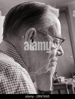 1970s PORTRAIT PROFILE OF SENIOR MAN WITH MUSTACHE AND WEARING EYEGLASSES - p7885 HAR001 HARS AND REFLECTIVE THINK REAR VIEW FACIAL HAIR GESTURES REFLECTING ELDERS PONDER PONDERING CONSIDER LOST IN THOUGHT FROM BEHIND BACK VIEW BLACK AND WHITE CAUCASIAN ETHNICITY CONSIDERING HAR001 OLD FASHIONED Stock Photo