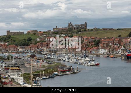 Whitby, North Yorkshire, England, UK - July 5th 2023 - View over the harbour of the town of Whitby with the derelict abbey in the background Stock Photo