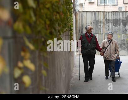 Li Chang and his wife Zhang Guiqin take a stroll in Taiyuan, capital of north China s Shanxi Province, Oct. 21, 2015. Retired Chinese engineer Li Chang, an extensive collector in antique mechanic products, is now planning to raise fund on the internet to realize a promise he made to his wife. Li Chang married his wife, Zhang Guiqin, in 1958 and he made the promise at their golden wedding anniversary. Li Chang owns a WWII German Brunsvigr mechanical calculator which is in good condition. Recently, Li Chang posted an advertisement to sell the calculator through Wechat, one of China s most popula Stock Photo