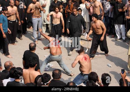 (151025) -- LAHORE, Oct. 24, 2015 -- Pakistani Shiite Muslims flagellate themselves during a procession marking the holy day of Ashura in eastern Pakistan s Lahore, Oct. 24, 2015. Ashura is the annual Shiite Muslim commemoration marking the death of Imam Hussein, the grandson of the Prophet Muhammad, in the seventh century battle of Karbala. ) PAKISTAN-LAHORE-ASHURA-RITUAL JamilxAhmed PUBLICATIONxNOTxINxCHN   Lahore OCT 24 2015 Pakistani Shiite Muslims flagellates themselves during a Procession marking The Holy Day of Ashura in Eastern Pakistan S Lahore OCT 24 2015 Ashura IS The Annual Shiite Stock Photo