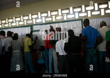 (151025) -- PORT AU PRINCE, Oct. 25, 2015 -- People search their names in electoral lists during the general elections at a polling station, in Port au Prince, Haiti, on Oct. 25, 2015. The next phase of the electoral process in Haiti took place on Sunday with the first round of presidential elections, the second round of legislative elections and the holding of municipal elections. The Oct. 25 vote is expected to clear the sprawling presidential field for a runoff Dec. 27 between the top two finishers. Luz Sosa) (vf) (fnc) HAITI-PORT AU PRINCE-POLITICS-ELECTIONS e LuzxSosa PUBLICATIONxNOTxINxC Stock Photo