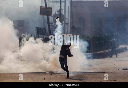 (151030) -- SRINAGAR, Oct. 30, 2015 -- A Kashmiri Muslim protester throws an exploded tear smoke shell back at Indian police and paramilitary troopers (unseen) during a protest in Srinagar, summer capital of Indian-controlled Kashmir, Oct. 30, 2015. Kashmiri Muslim protesters clash with Indian police and paramilitary troopers after Friday prayers over the killing of Abu Qasim, a top militant commander heading Lashkar-e-Toiba (LeT) in restive Indian-controlled Kashmir. ) KASHMIR-SRINAGAR-CLASHES JavedxDar PUBLICATIONxNOTxINxCHN   Srinagar OCT 30 2015 a Kashmiri Muslim protester throws to explod Stock Photo