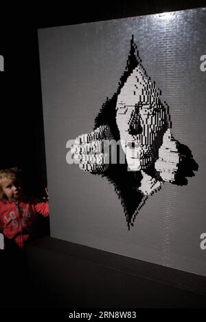 (151106) -- ROME, Nov. 6, 2015 -- A visitor walks past Grey, an artwork by American artist Nathan Sawaya, at the exhibition the Art of the Brick in Rome, Italy, on Nov. 6, 2015. The exhibition, which kicked off on Friday and will last untill next February, showcases around 70 contemporary artworks created by American artist Nathan Sawaya with LEGO bricks. ) ITALY-ROME-ART-EXHIBITION-LEGO JinxYu PUBLICATIONxNOTxINxCHN   Rome Nov 6 2015 a Visitor Walks Past Grey to Artwork by American Artist Nathan Sawaya AT The Exhibition The Art of The Brick in Rome Italy ON Nov 6 2015 The Exhibition Which kic Stock Photo