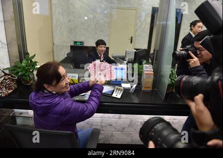 (151112) -- BEIJING, Nov. 12, 2015 -- Ms. Liu shows some new 100-yuan banknotes withdrawn from the Beijing Branch of the Bank of Communication in Beijing, capital of China, Nov. 12, 2015. China s central bank released a new 100-yuan banknote on Thursday. The design stays largely the same as its former series, but the new banknotes are harder to conterfeit and easier for machines to read. The 100-yuan note is the largest denomination of the Chinese currency. ) (lfj) CHINA-NEW BANKNOTE-RELEASE (CN) LixXin PUBLICATIONxNOTxINxCHN   Beijing Nov 12 2015 MS Liu Shows Some New 100 Yuan banknotes withd Stock Photo