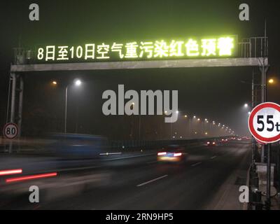 (151208) -- BEIJING, Dec. 8, 2015 -- An electronic road sign reminds a red alert for air pollution in Beijing, capital of China, Dec. 8, 2015. Beijing has issued its first red alert for air pollution under a four-tier emergency response system created in October 2013. The red alert, the most serious level, will last from 7 a.m. on Tuesday to noon on Thursday. Under a red alert, the city s emergency management headquarters has advised kindergartens, primary and high schools to suspend classes, banned outdoor operations on construction sites and required some industrial plants to limit or stop p Stock Photo