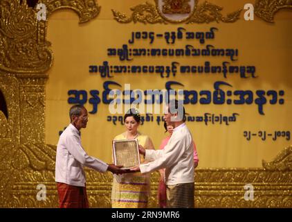 (151212) -- YANGON, Dec. 12, 2015 -- Myanmar Vice President Dr. Sai Mauk Kham (R, front) presents the National Literary Award to a literary winner at National Theatre in Yangon, Myanmar, Dec. 12, 2015. Altogether 18 literati won National Literary Awards (NLA) for 2014 in Myanmar, the National Literary Award Scrutiny Committee announced on Saturday. ) MYANMAR-YANGON-NATIONAL LITERARY AWARD CEREMONY UxAung PUBLICATIONxNOTxINxCHN   151212 Yangon DEC 12 2015 Myanmar Vice President Dr Sai Mauk Kham r Front Presents The National Literary Award to a Literary Winner AT National Theatre in Yangon Myanm Stock Photo