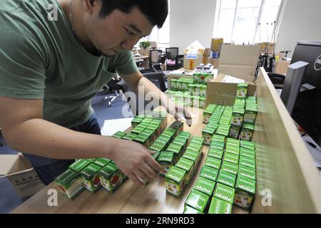 (151217) -- BEIJING, Dec. 17, 2015 -- A staff worker packages export product samples at the xbniao e-business platform in Beijing, capital of China, Aug. 19, 2015. As host of the Second World Internet Conference (WIC) that is underway in Wuzhen in east China s Zhejiang Province, China called for global Internet interconnectivity and shared governance by all. As one of the greatest inventions of the 20th century, the Internet has turned the globe into a village and profoundly changed the way people live and do business. Since 1994, when China gained access to international web service, the coun Stock Photo