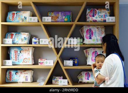 (151217) -- BEIJING, Dec. 17, 2015 -- File photo taken on Aug. 24, 2015 shows a customer looking at goods at an e-commerce bonded store in Hangzhou, capital of east China s Zhejiang Province. As host of the Second World Internet Conference (WIC) that is underway in Wuzhen in east China s Zhejiang Province, China called for global Internet interconnectivity and shared governance by all. As one of the greatest inventions of the 20th century, the Internet has turned the globe into a village and profoundly changed the way people live and do business. Since 1994, when China gained access to interna Stock Photo