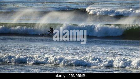 (151217) -- CALIFORNIA, Dec. 17, 2015 -- Photo taken in September 2013 shows a man surfing in the sea in Monterey where is the starting point of 17-Mile Drive in California, the United States. 17-Mile Drive is widely recognized as one of the most scenic drives in the world. The famous coastal landmark runs through Pacific Grove to Pebble Beach, from the dramatic Pacific coastline to the majestic Del Monte Forest.) U.S.-CALIFORNIA-17-MILE DRIVE-SCENERY YangxLei PUBLICATIONxNOTxINxCHN   151217 California DEC 17 2015 Photo Taken in September 2013 Shows a Man Surfing in The Sea in Monterey Where I Stock Photo